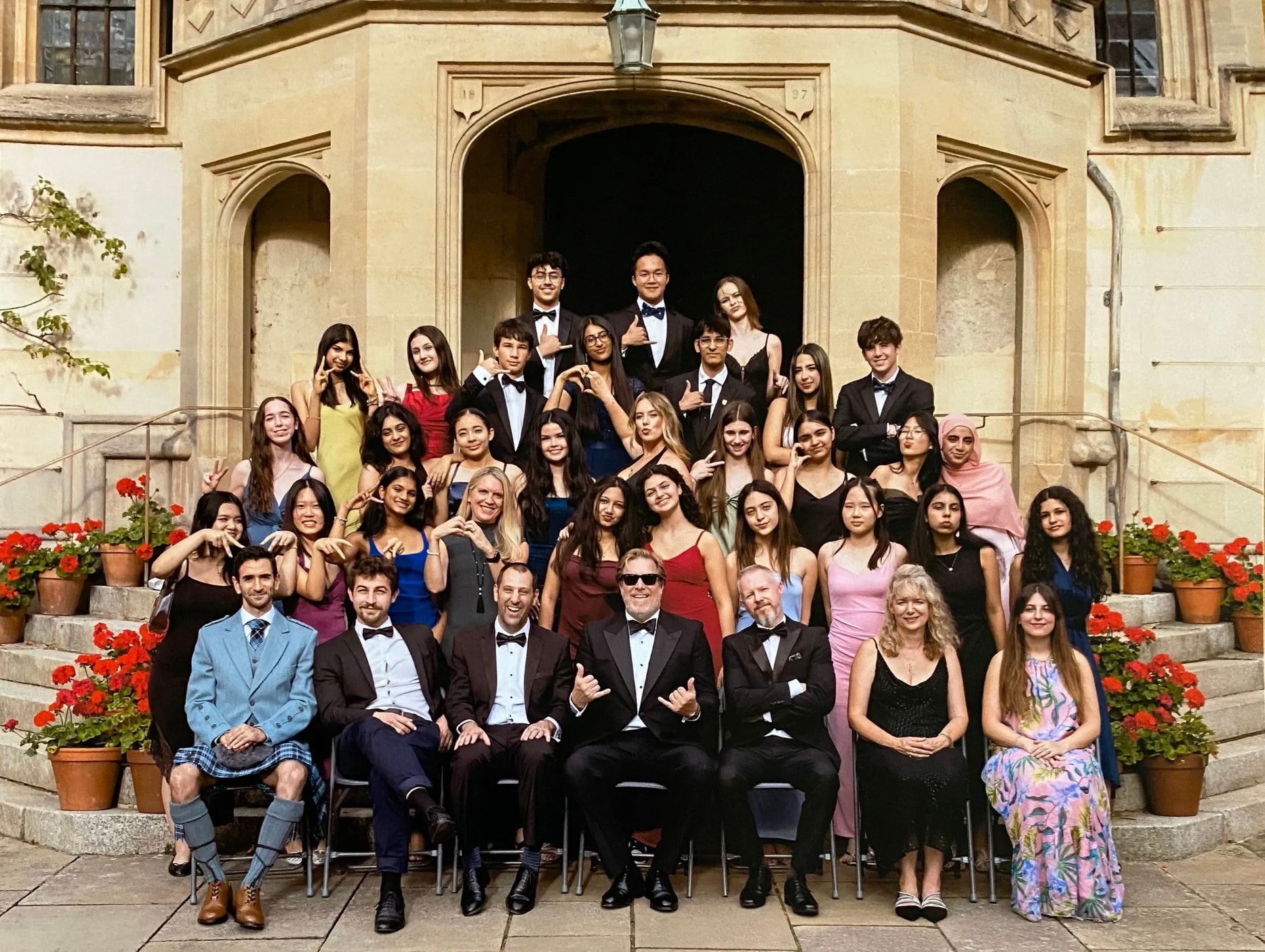 Oxford IQ Academy students and faculty at the 2025 graduation ceremony on the steps of an Oxford college